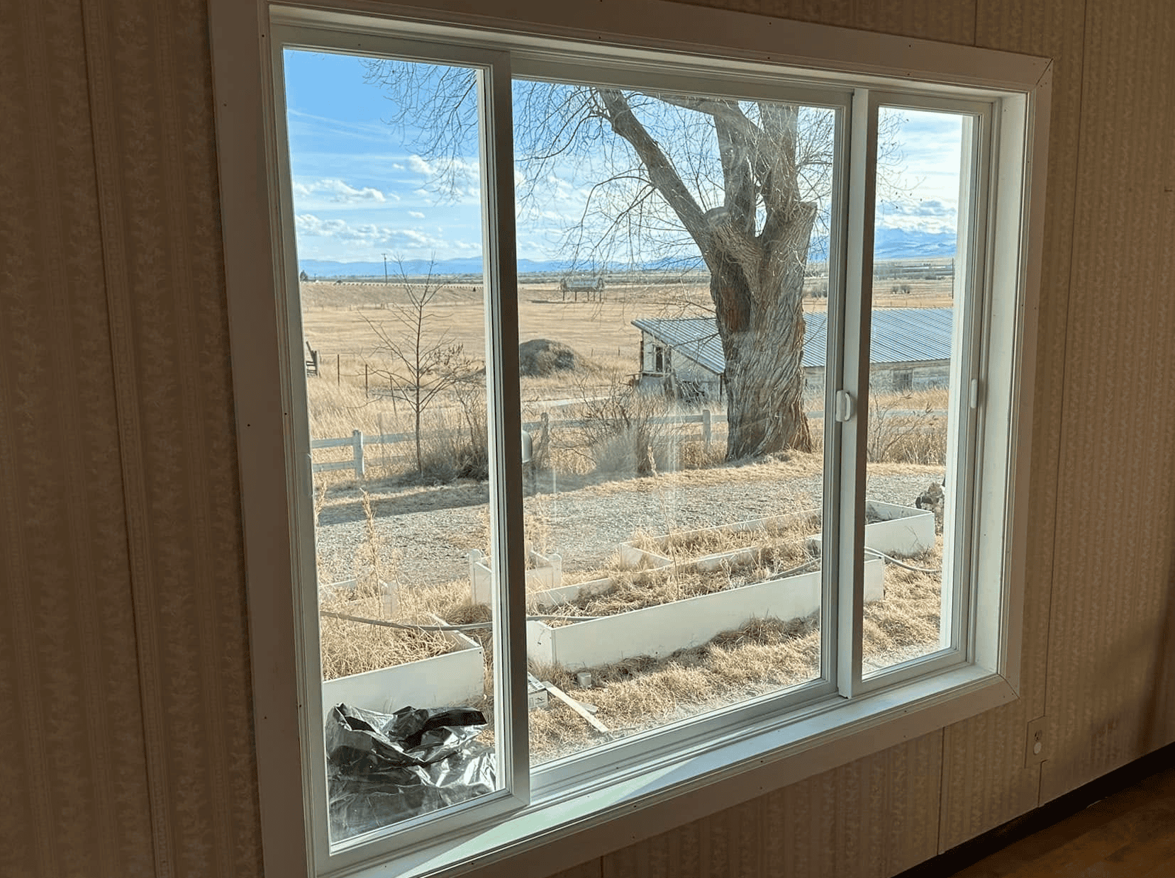 Window Installation in Rural Area Window installation with a scenic rural landscape view.