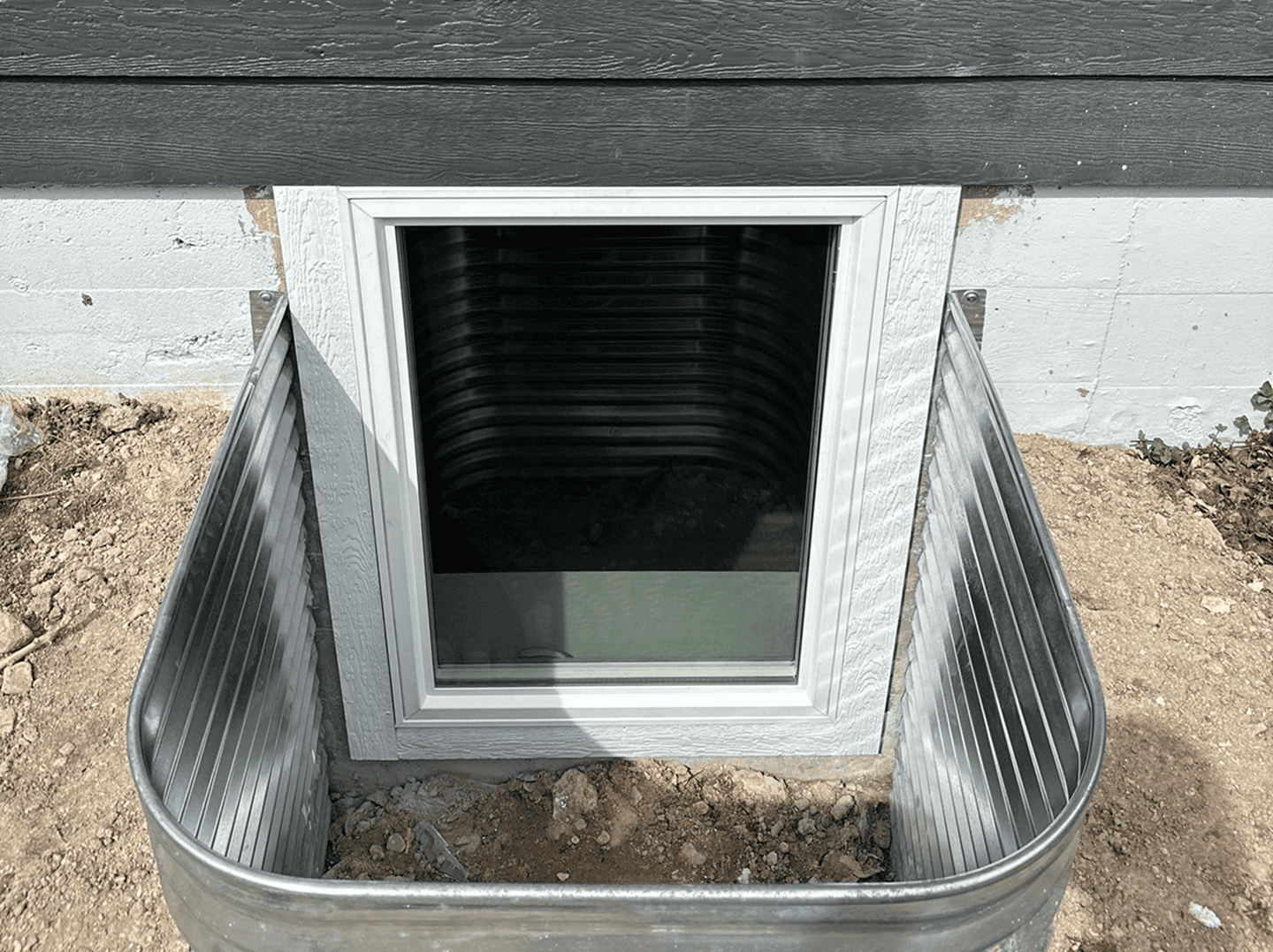 Window Well Cover Window well cover with metal sides for basement window protection.