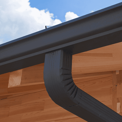 Gutter system installed on a building with black downspout and wooden soffit, showcasing quality roo.