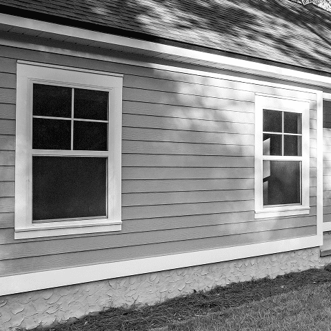 New double-hung windows installed on house exterior.