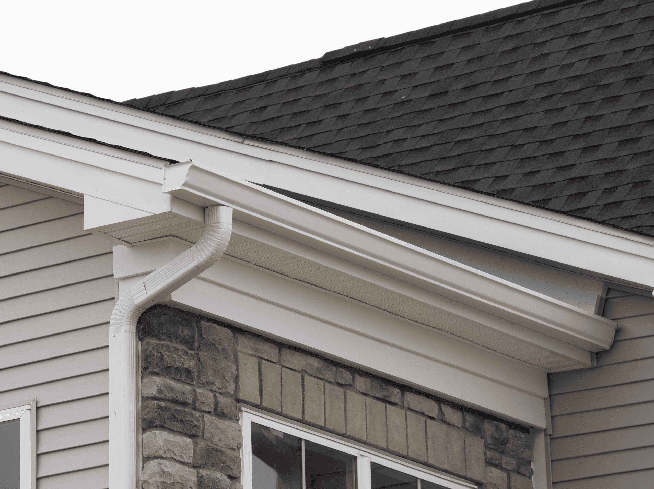 Modern house exterior with new siding, roof, and gutter system.