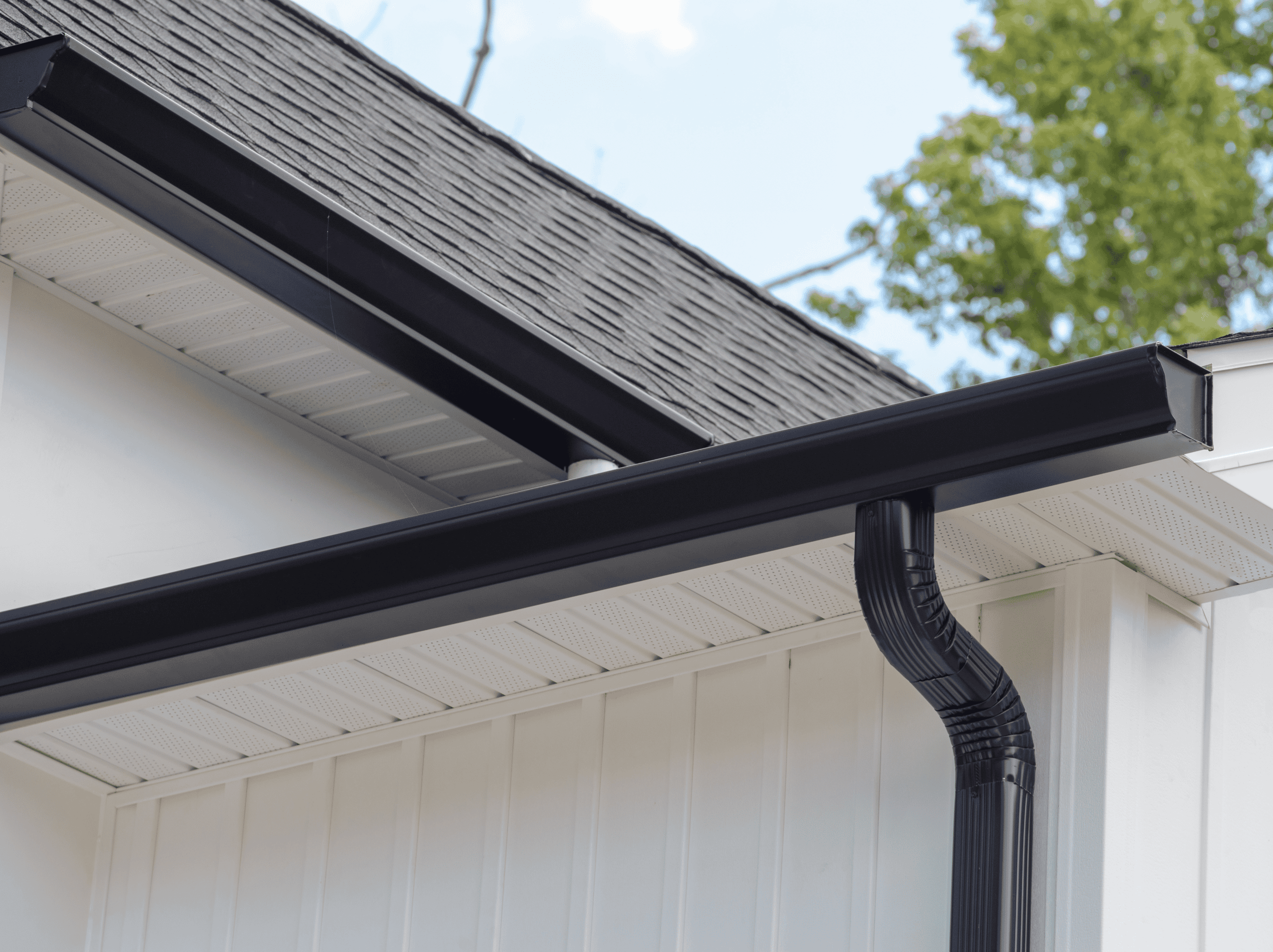 Professional gutter installation on residential home for effective water drainage.