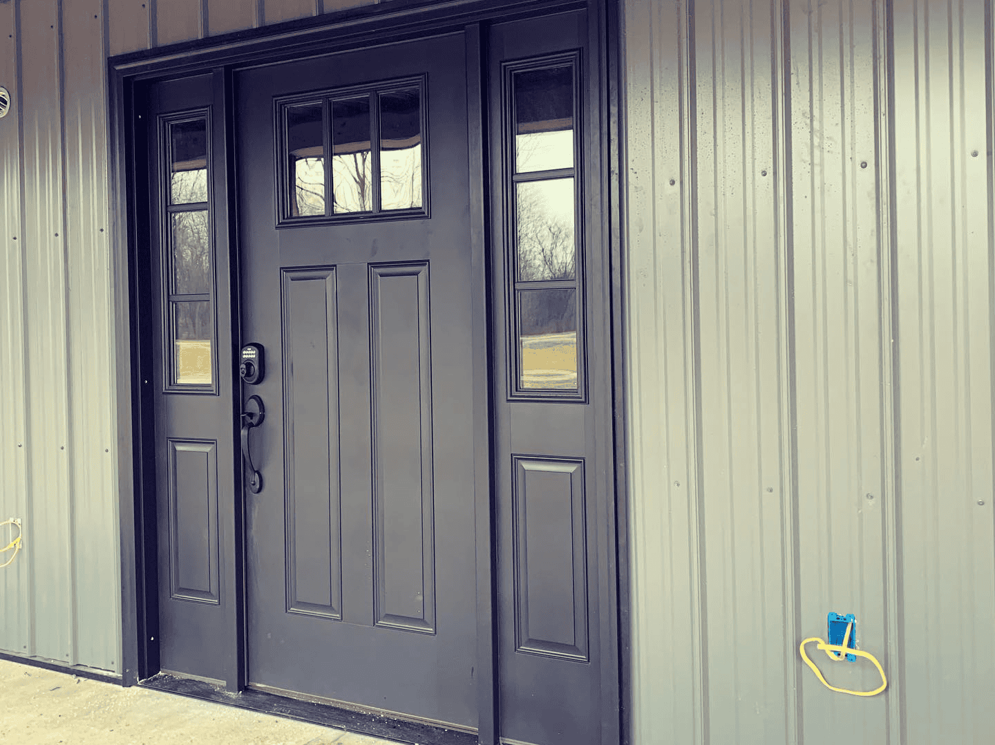 Modern Metal Door Durable metal door with window panels, ideal for commercial or industrial buildings.