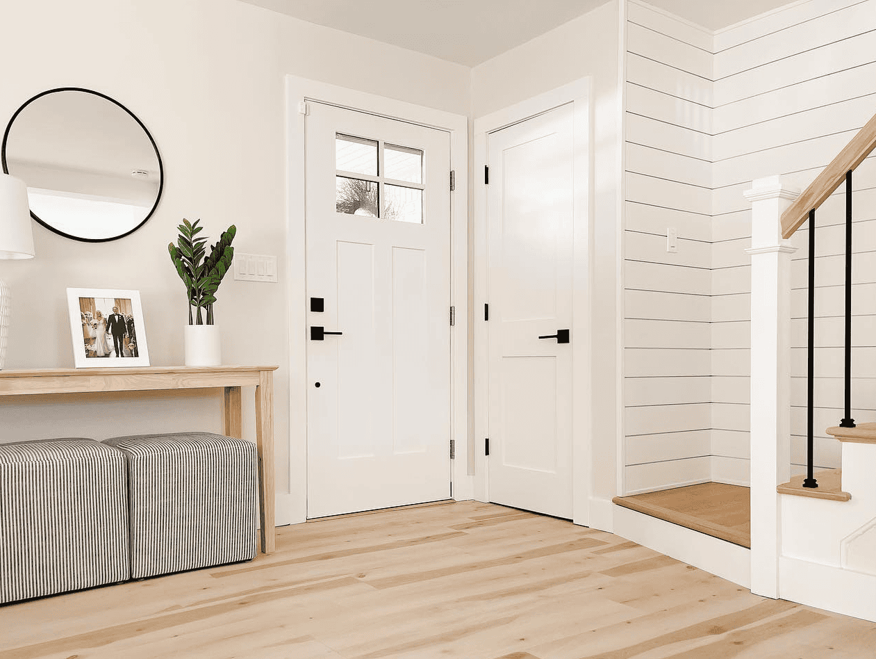 Modern Entryway Design Bright and welcoming entryway with white doors, wooden accents, and modern decor.