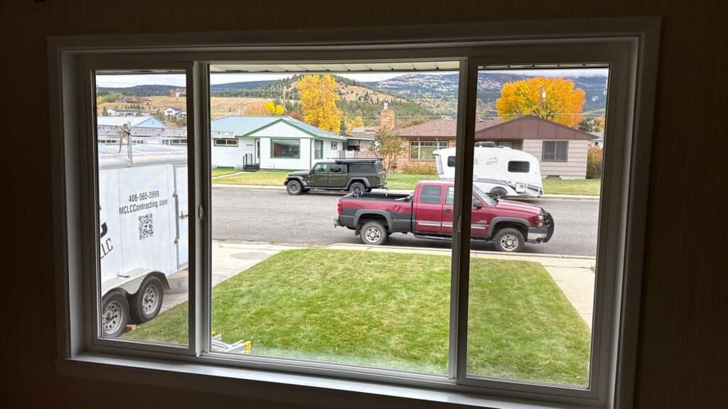 Home Exterior View View of residential homes and vehicles from a window, showcasing neighborhood surroundings.