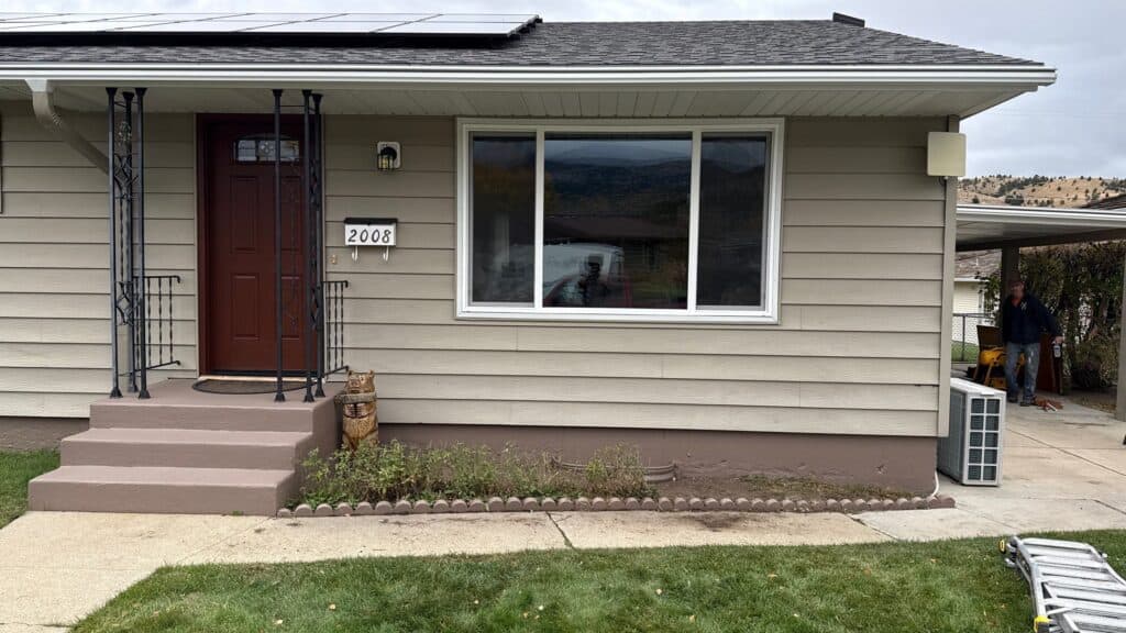 Home Exterior Renovation Modern home exterior with new siding, window, and landscaping by Example Co.