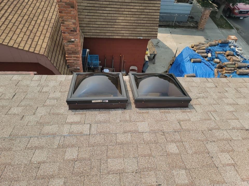 Roof Skylights Installation Two black roof skylights installed on a residential roof.