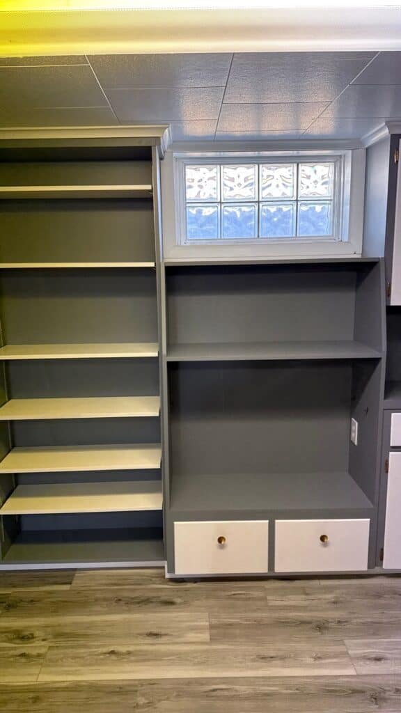 Modern Storage Unit Custom gray built-in storage with shelves and drawers in a contemporary room.
