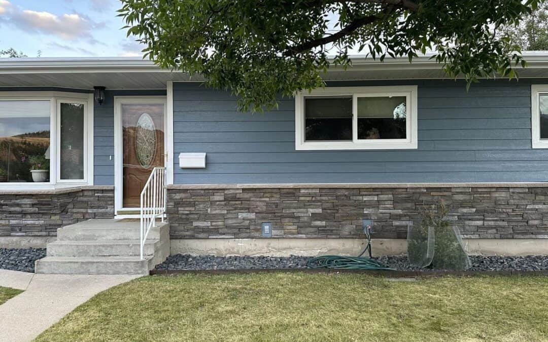Blue house with stone accents and front steps.