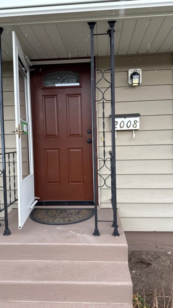 Front Door Entrance Front door of a residential home with security bars and house number 2008.