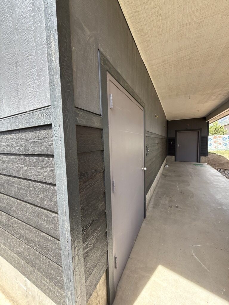 Storage closet door on building exterior.