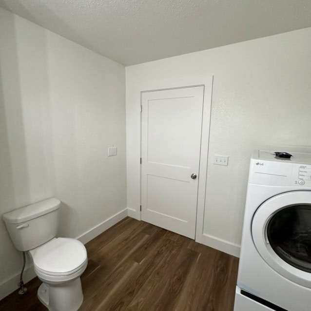 Toilet Room with Washer Toilet and washing machine in a small laundry room.