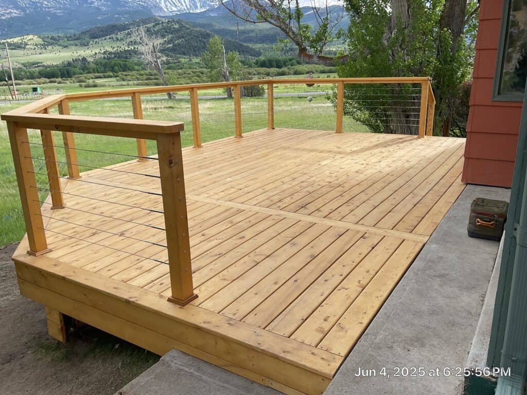 Deck Construction Deck with wooden railing overlooking scenic mountain landscape.