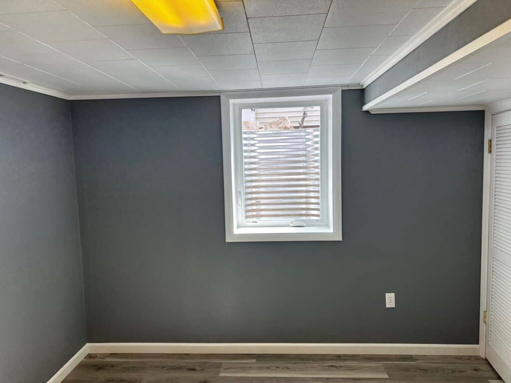 Modern Office Interior Interior of a modern office room with gray walls, ceiling, and window blinds.