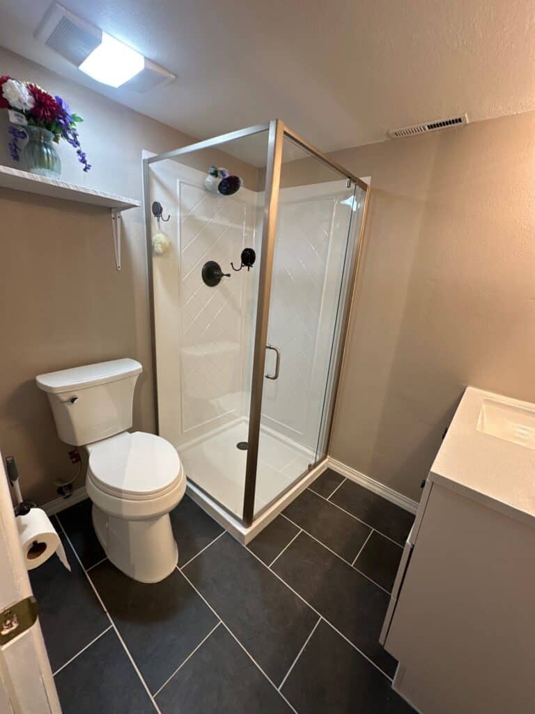Modern Bathroom Shower Enclosure Enclosed glass shower with black fixtures in a contemporary bathroom setting.