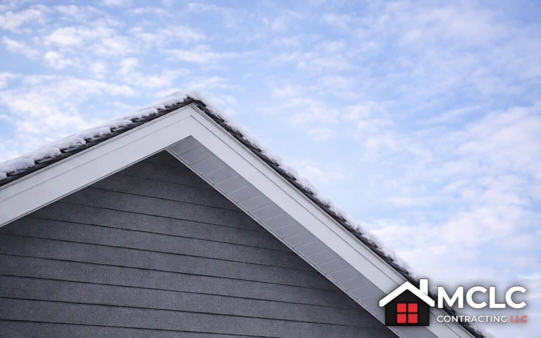 Roof with snow and overhang in winter season, showcasing residential construction quality.