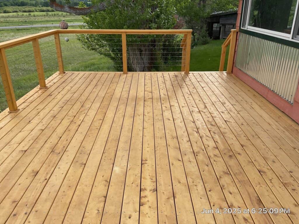 Wooden deck construction with railing Custom wooden deck with railing installed for outdoor living space.