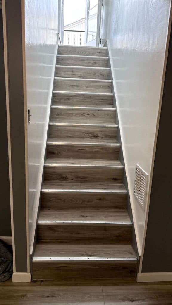 Modern Interior Staircase Interior staircase with wooden steps and white walls, leading to an upper level.