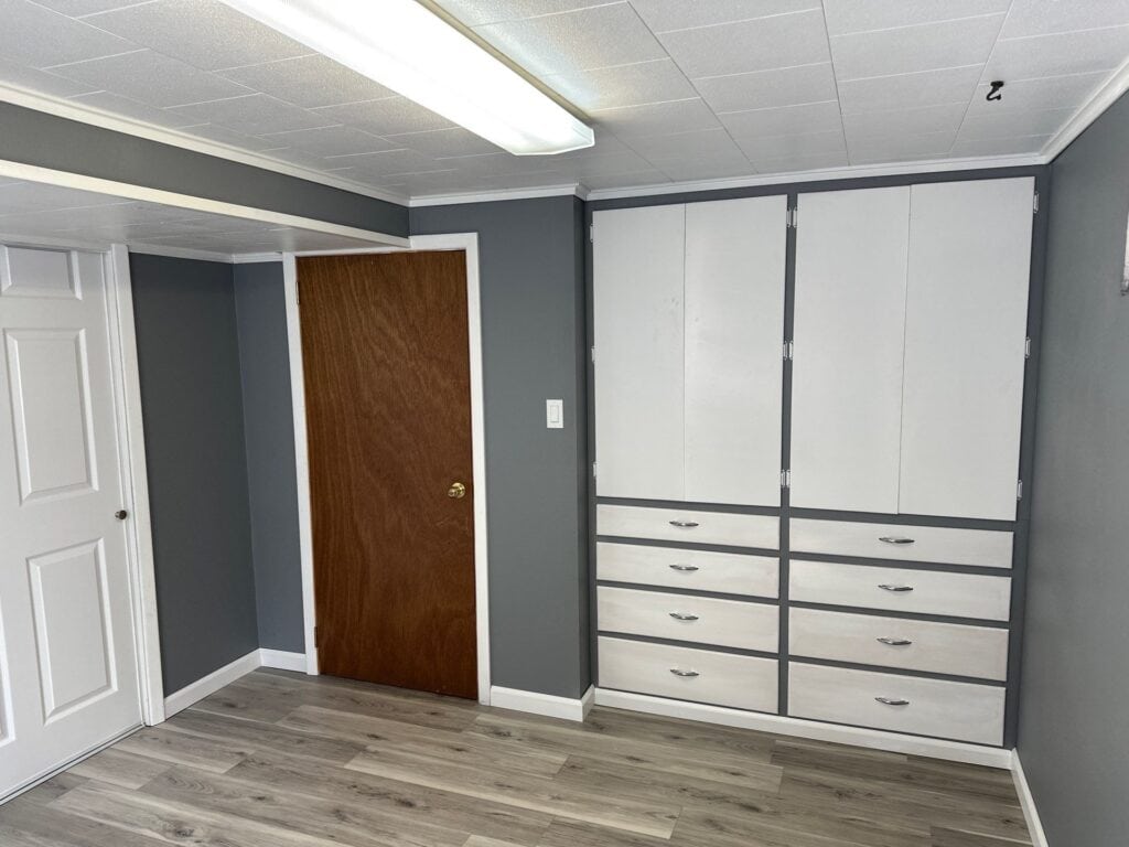 Modern Office Storage Custom built-in white office storage cabinets with drawers in a professional workspace.