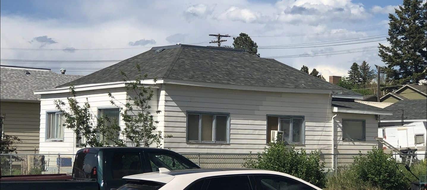 Residential house with new roofing and siding, showcasing quality home improvement services.