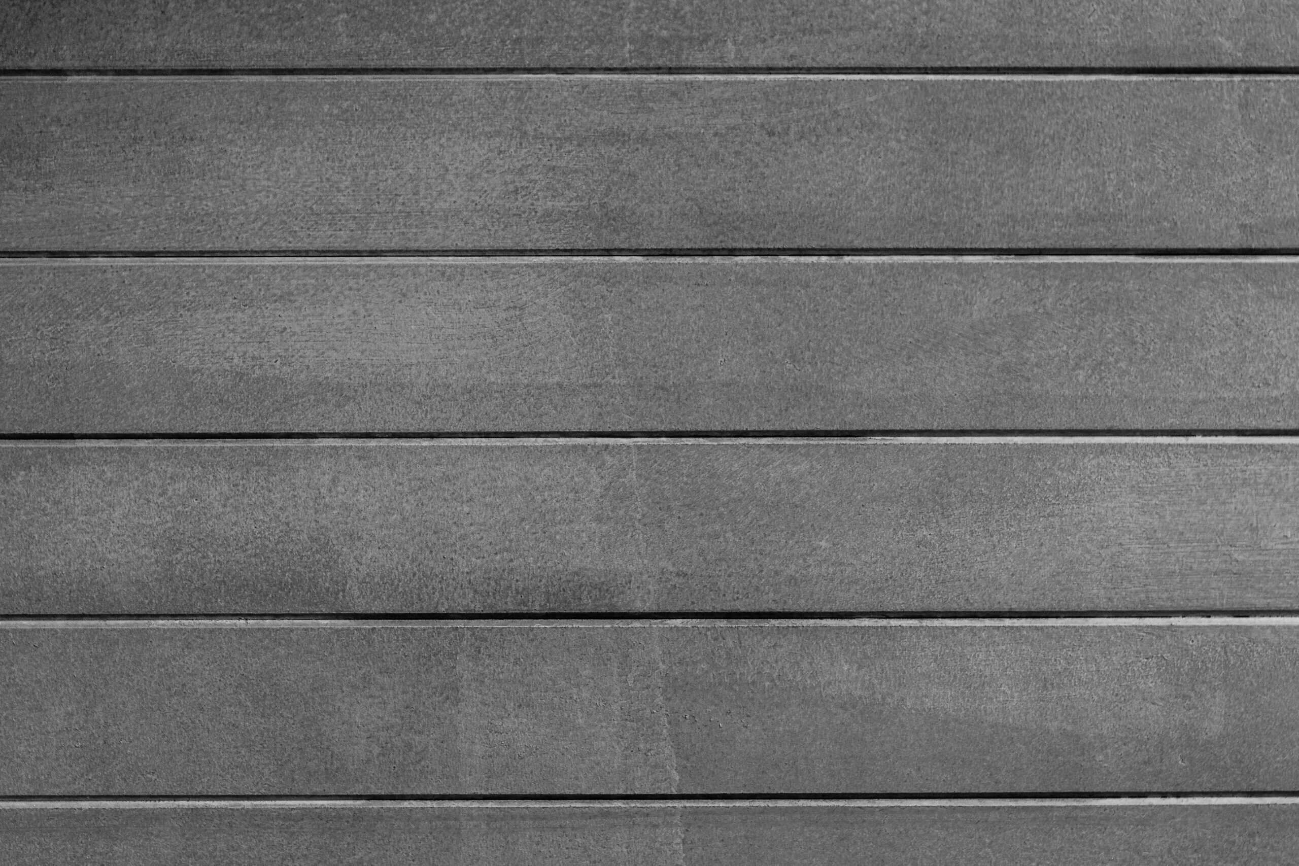 Close-up of gray wooden wall panels showing texture and grain.