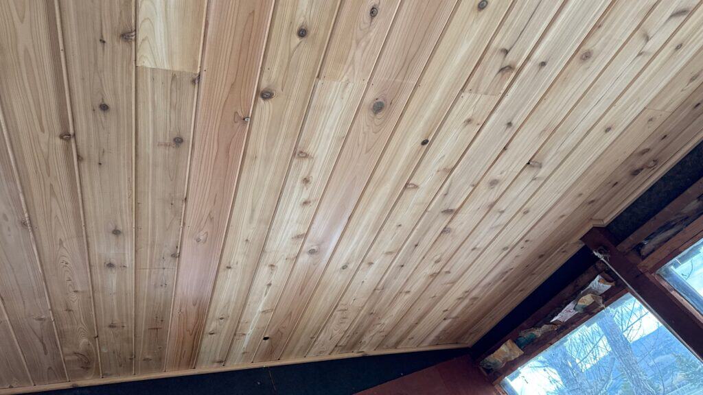 Close-up of wooden ceiling with natural finish in a residential space.