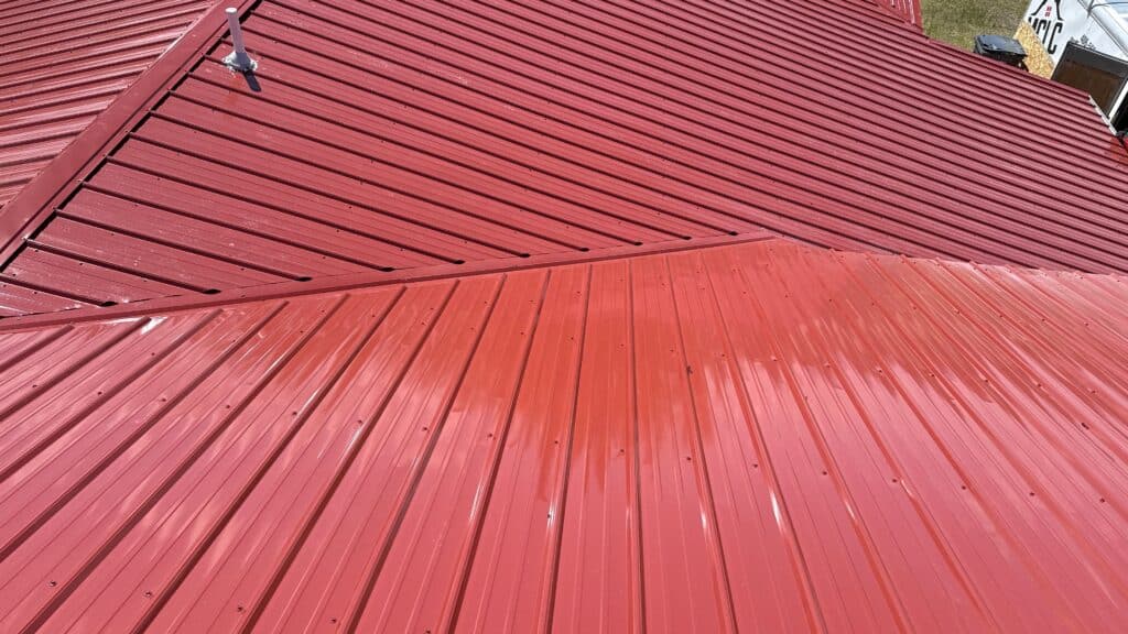Close-up of a red metal roof with standing seam panels.